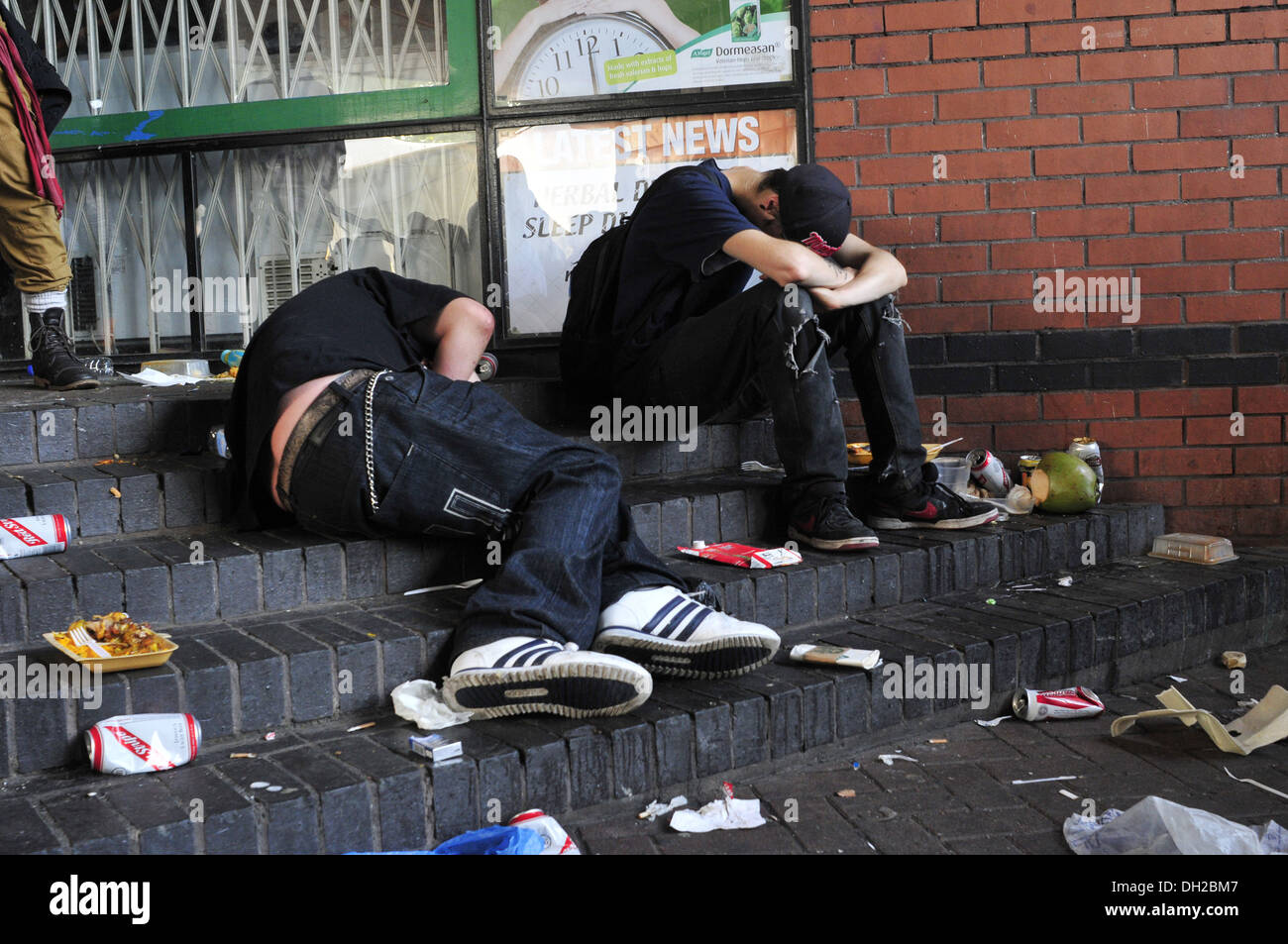 two-drunk-people-lay-on-the-floor-at-the-notting-hill-carnival-DH2BM7.jpg